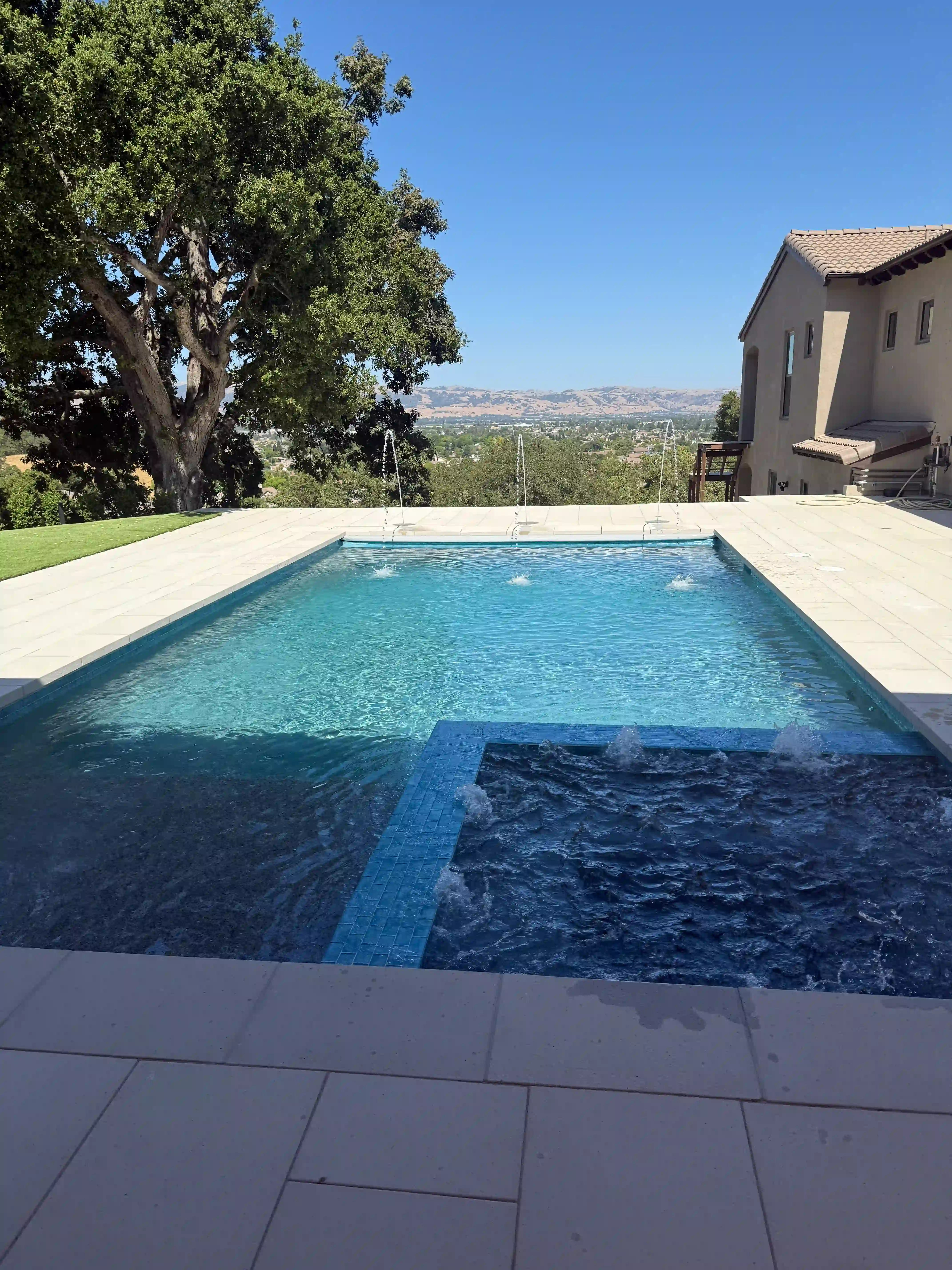 Beautifully crafted custom pool with natural stone accents by Legendary Pools Inc.